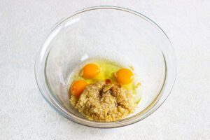 Wet ingredients for oatmeal cake in a mixing bowl.