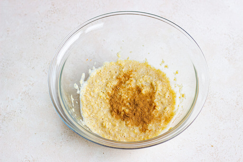 Cinnamon added to the mixing bowl.