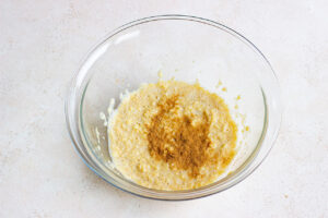 Cinnamon added to the mixing bowl.