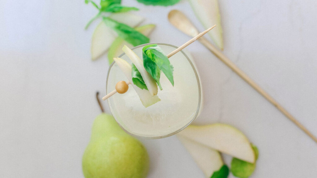 An overhead view of a glass filled with pear mocktail.
