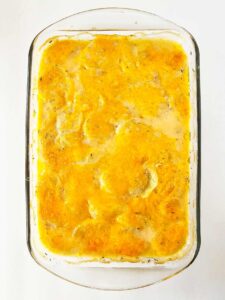 A casserole dish of potatoes au gratin just out of the oven. The cheese is visibly melted.