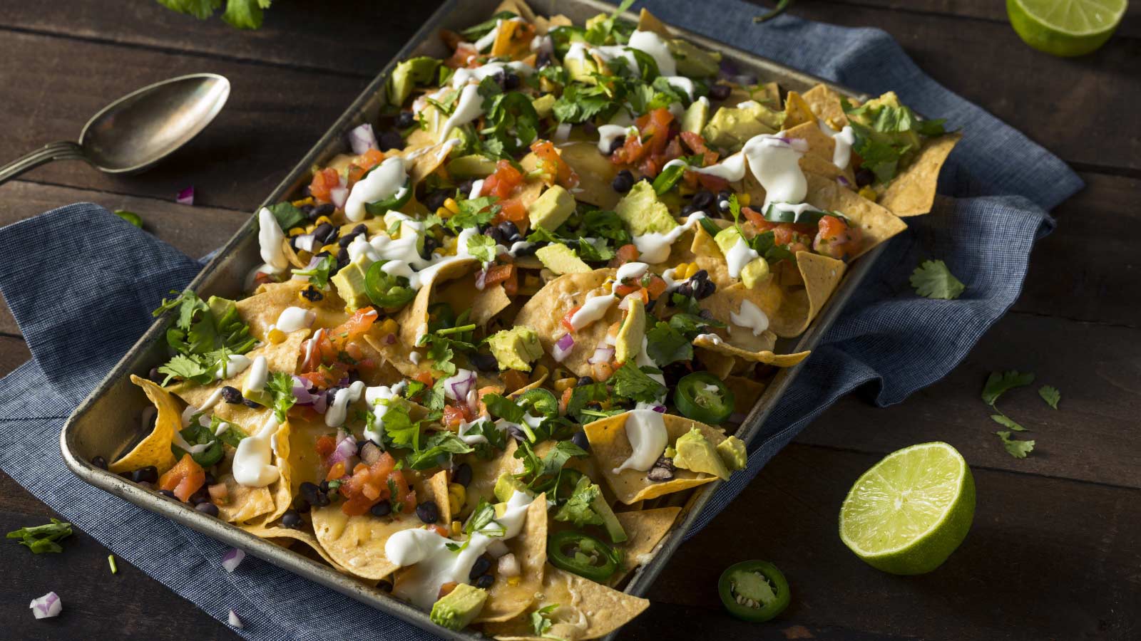 Homemade Loaded Sheet Pan Nachos with Cilantro Lime Tomato and Onion