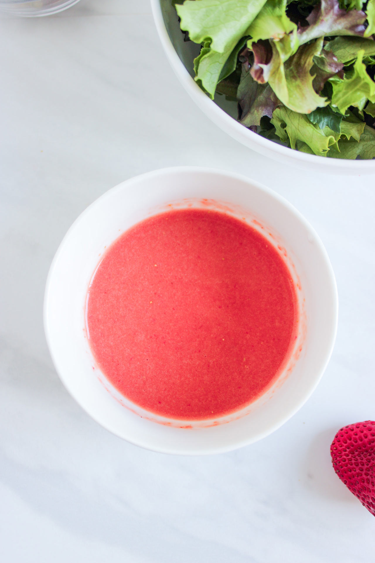Strawberry vinaigrette in a small white bowl.