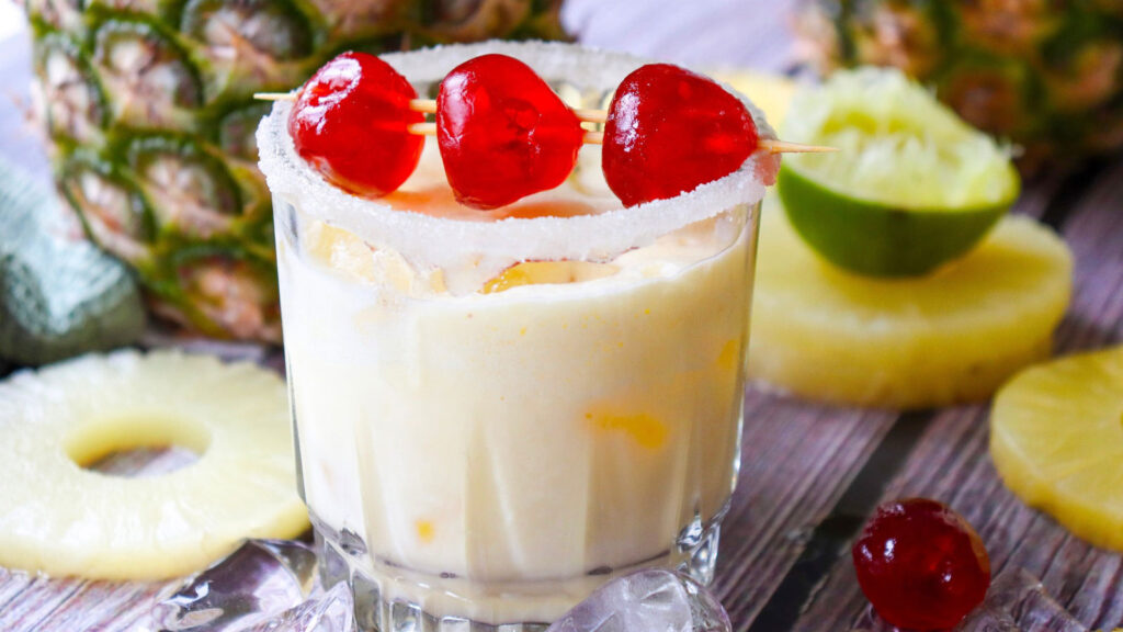 A side view of a glass filled wtih Virgin Pina Colada.