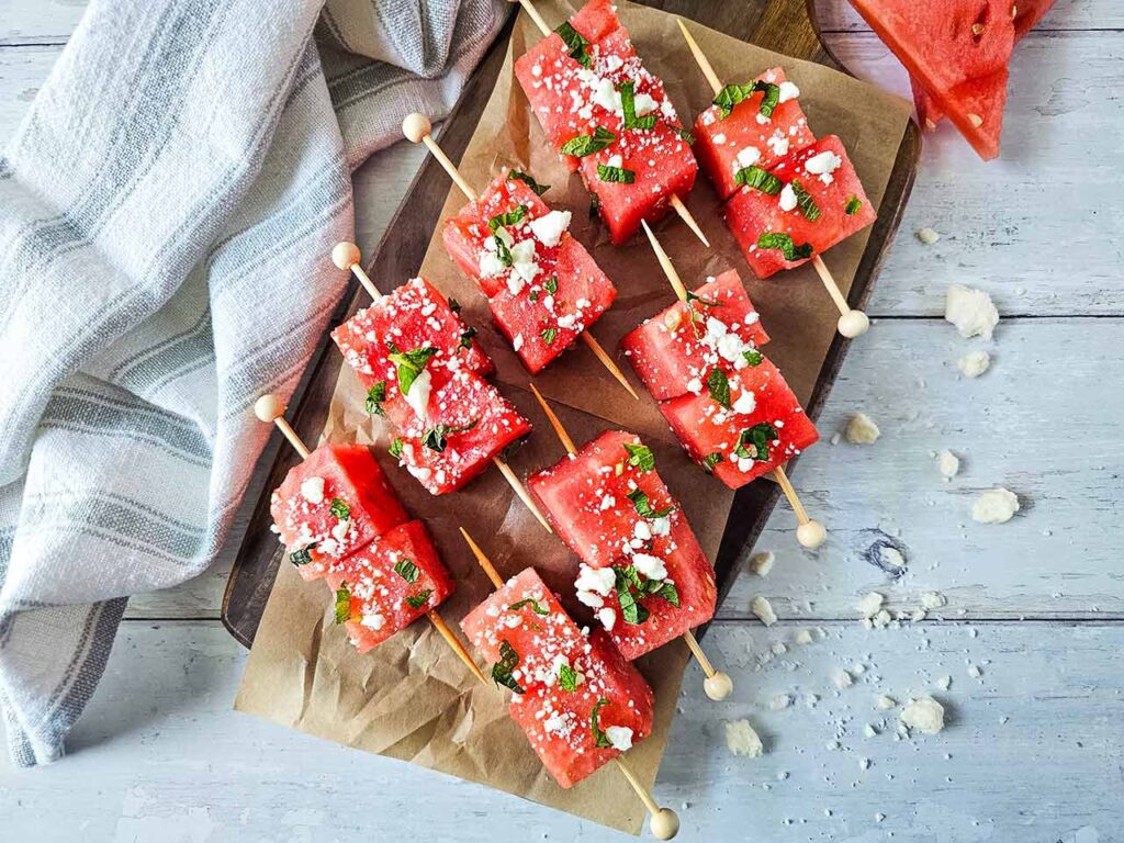 Watermelon Feta Skewers on parchment paper.