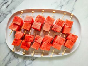 Ungarnished Watermelon Feta Skewers on a white, oval platter.