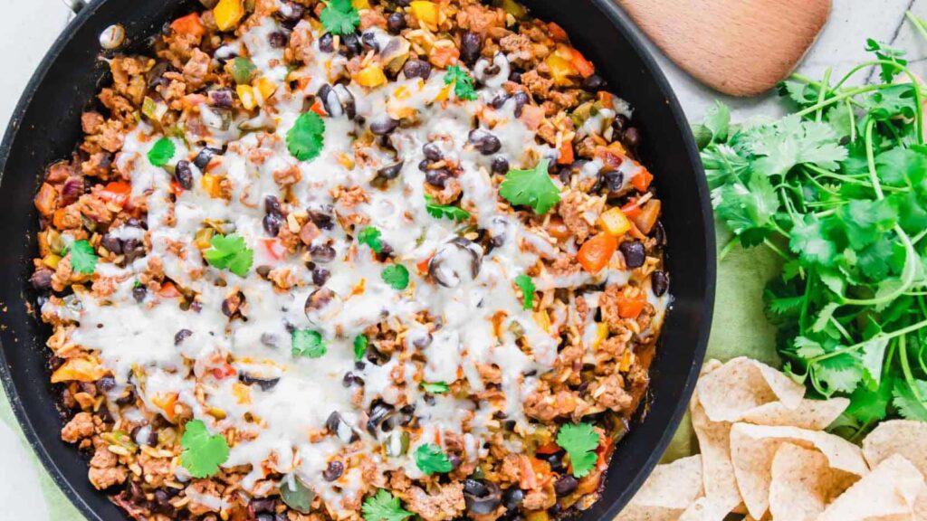 Overhead view of a black skillet filled with Mexican ground beef.