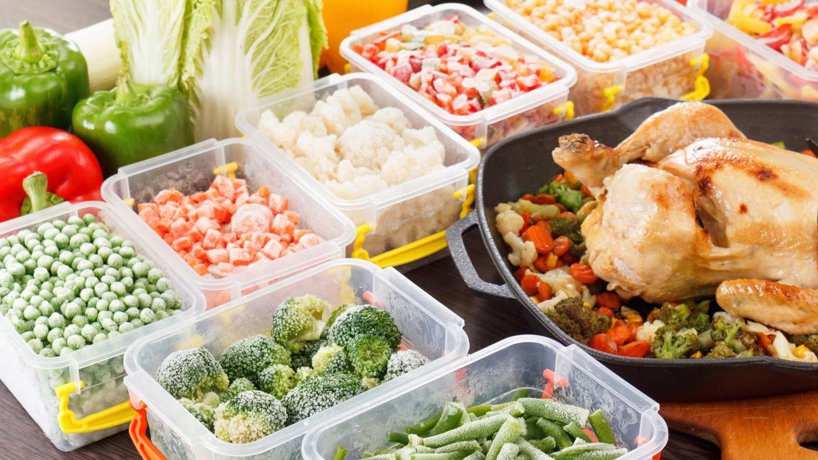 Stir fry vegetables frozen in plastic container, roasted chicken and veggies. Healthy freezer food in tray.