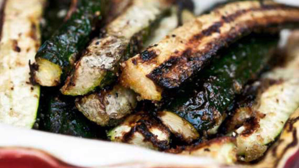 A closeup of grilled zucchini stick.