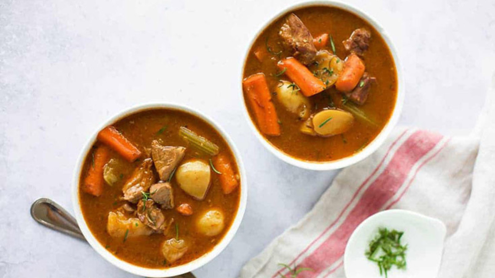 Two white bowls filled with Instant Pot beef stew.