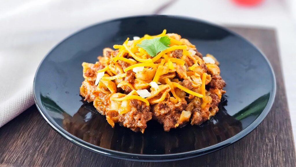 A black plate holds a serving of Instant Pot taco casserole.