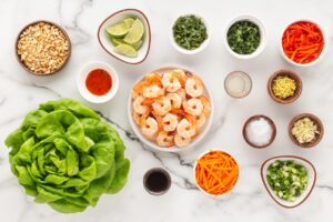 Ingredients for Thai Shrimp Lettuce Wraps on a white surface