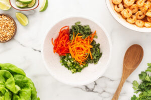 Fresh cut veggies in a white bowl.