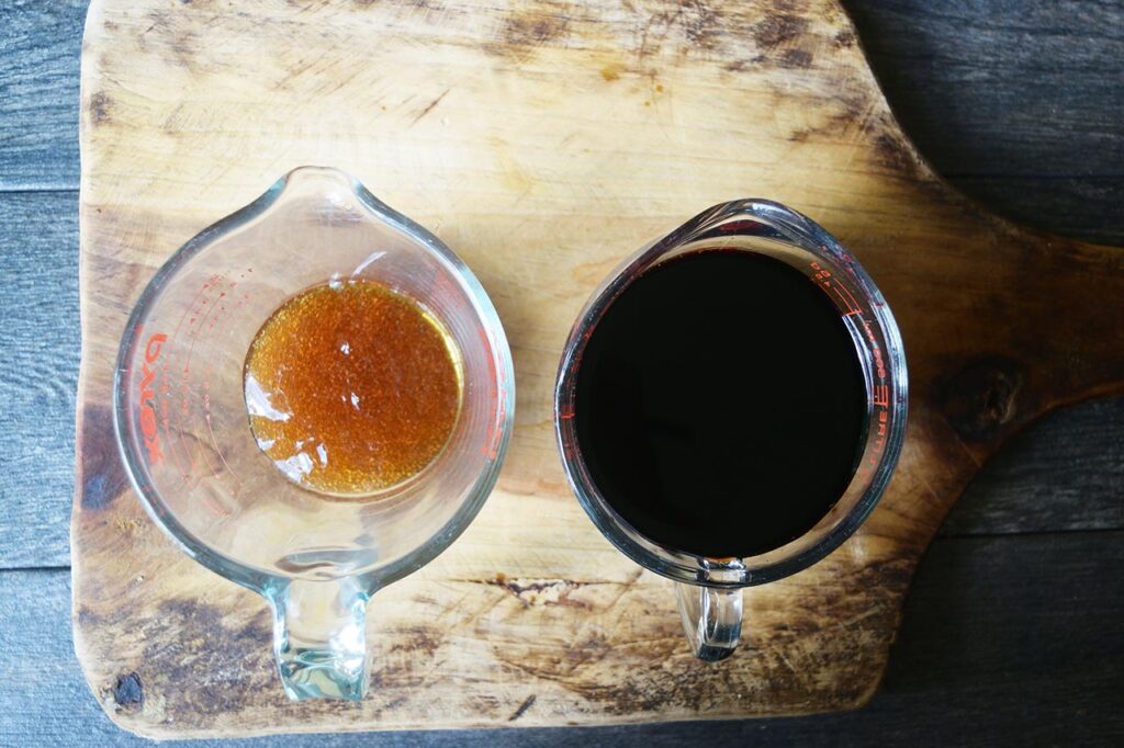 Balsamic glaze ingredients on a cutting board in measuring cups.
