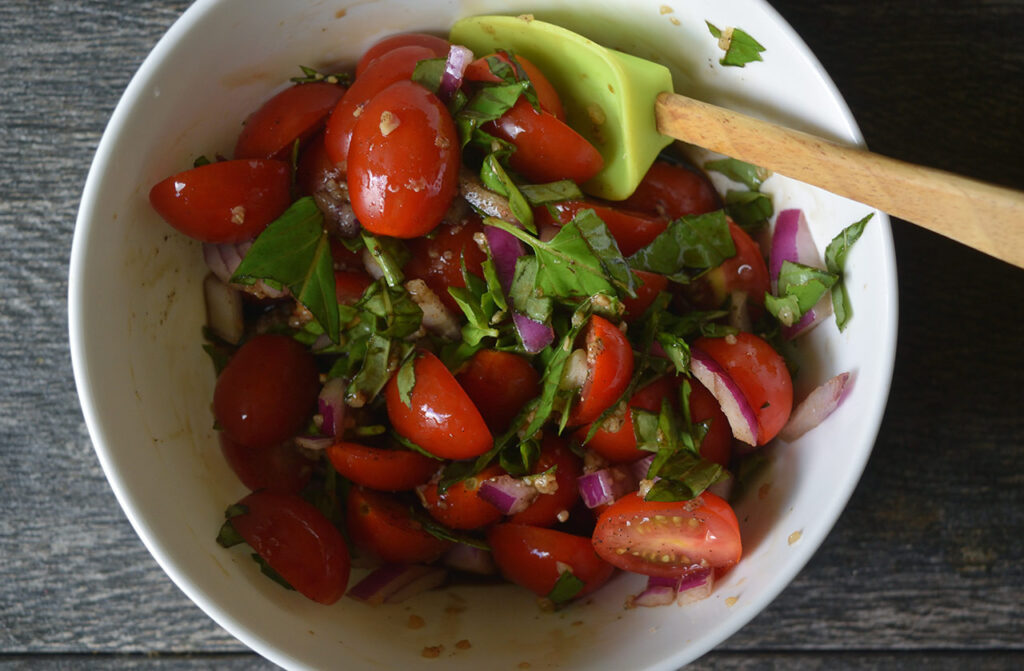 Bruschetta topping mixed in a white bowl.