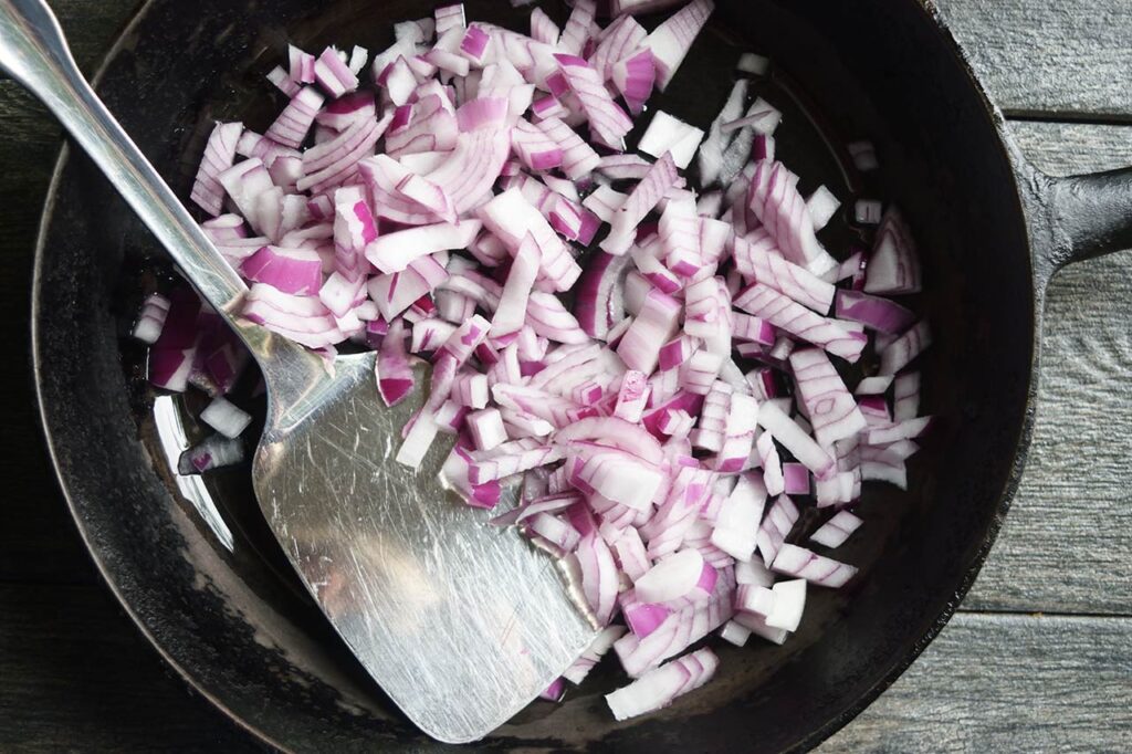 Sautéing onions in a skillet.