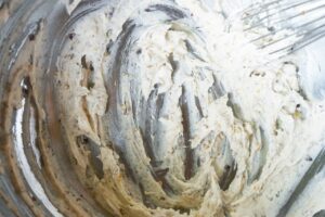 Creamy filling mixed together in a mixing bowl.