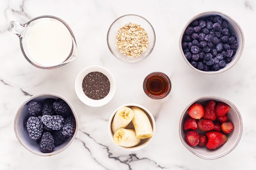 Grimace Shake Recipe ingredient in individual bowls on a white marble surface.