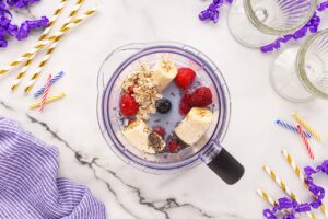 Grimace Shake recipe ingredients in a blender.