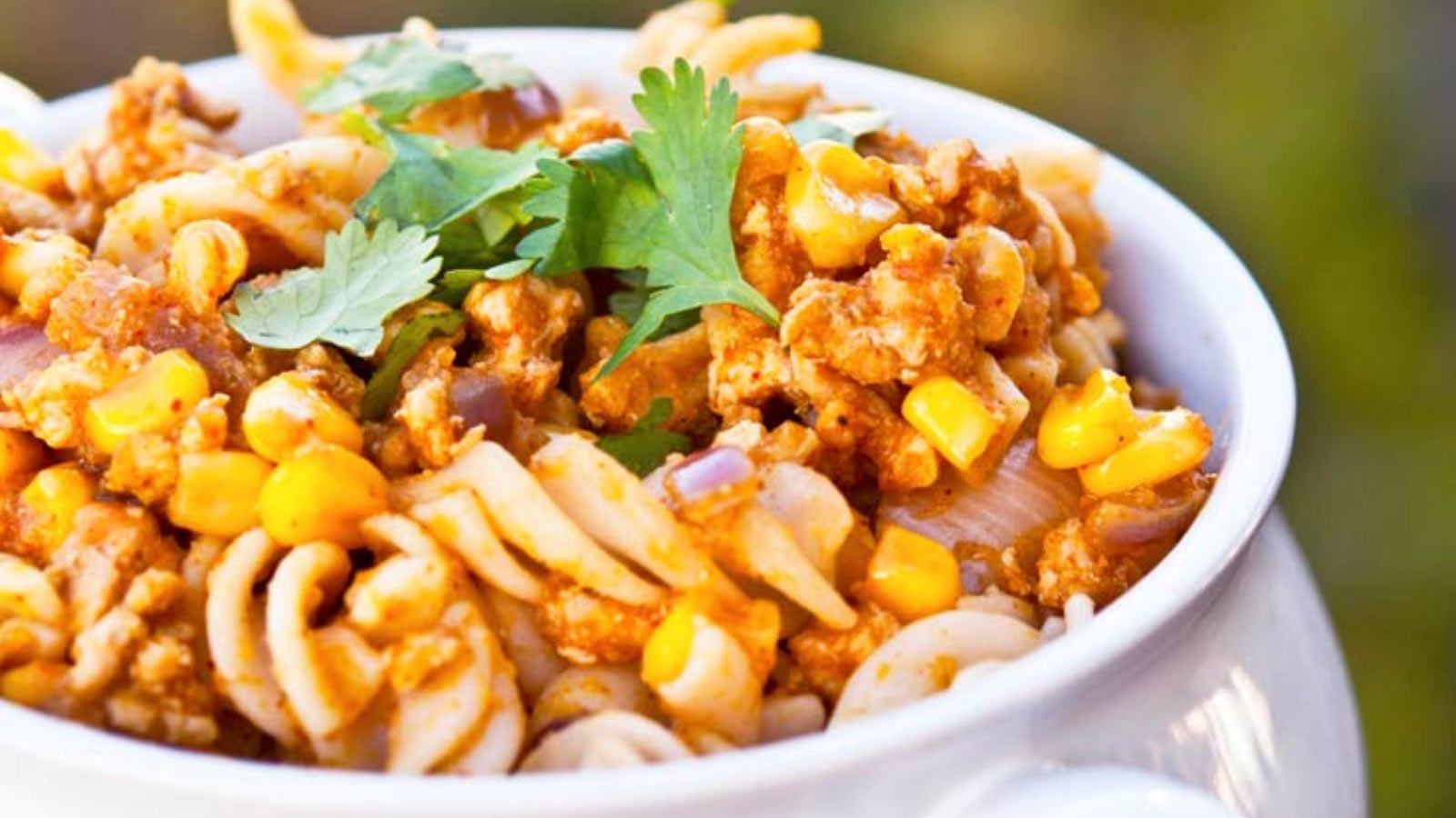 A white bowl full of Mexican pumpkin rotini. Close up view.