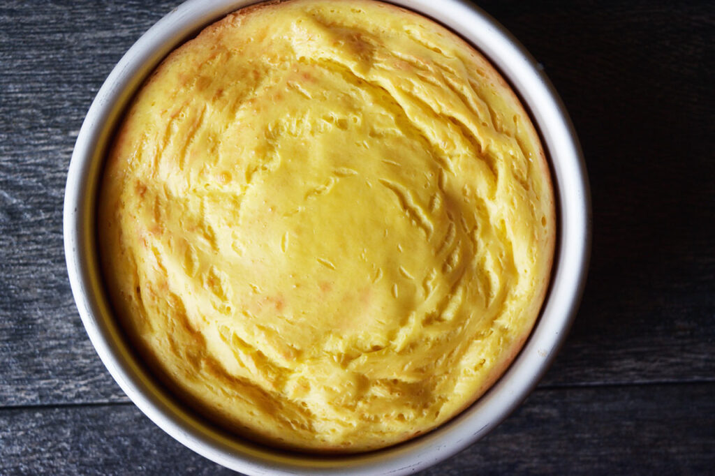 A baked yogurt cake cooking in a cake pan.