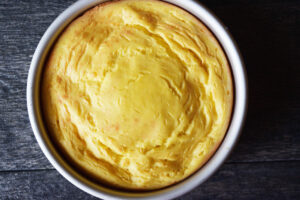 A baked yogurt cake cooking in a cake pan.