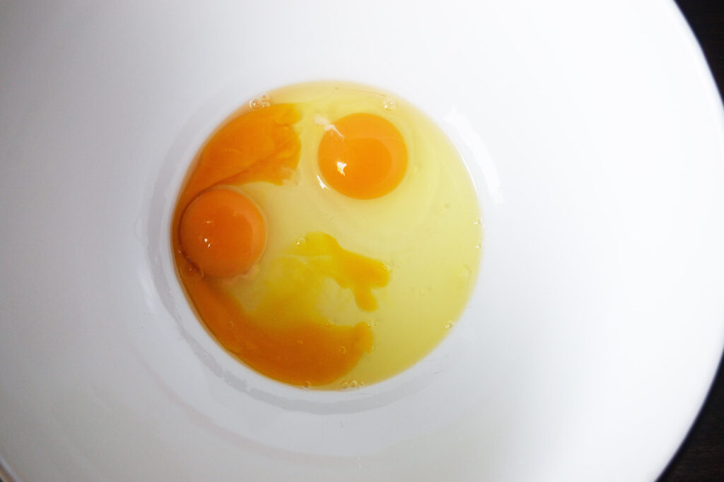 Eggs in a white mixing bowl.