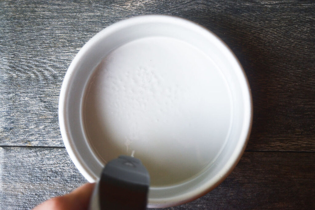 Oiling and lining a cake pan.