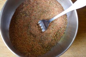 Blackening seasoning mixed together in a mixing bowl with a fork.