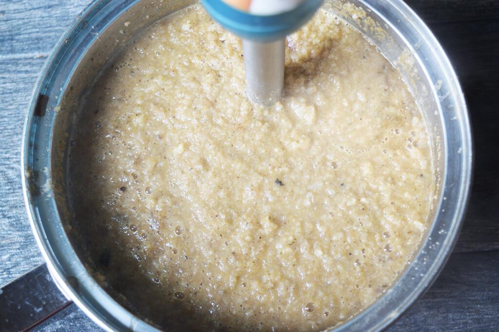 Blending cauliflower soup in a pot.