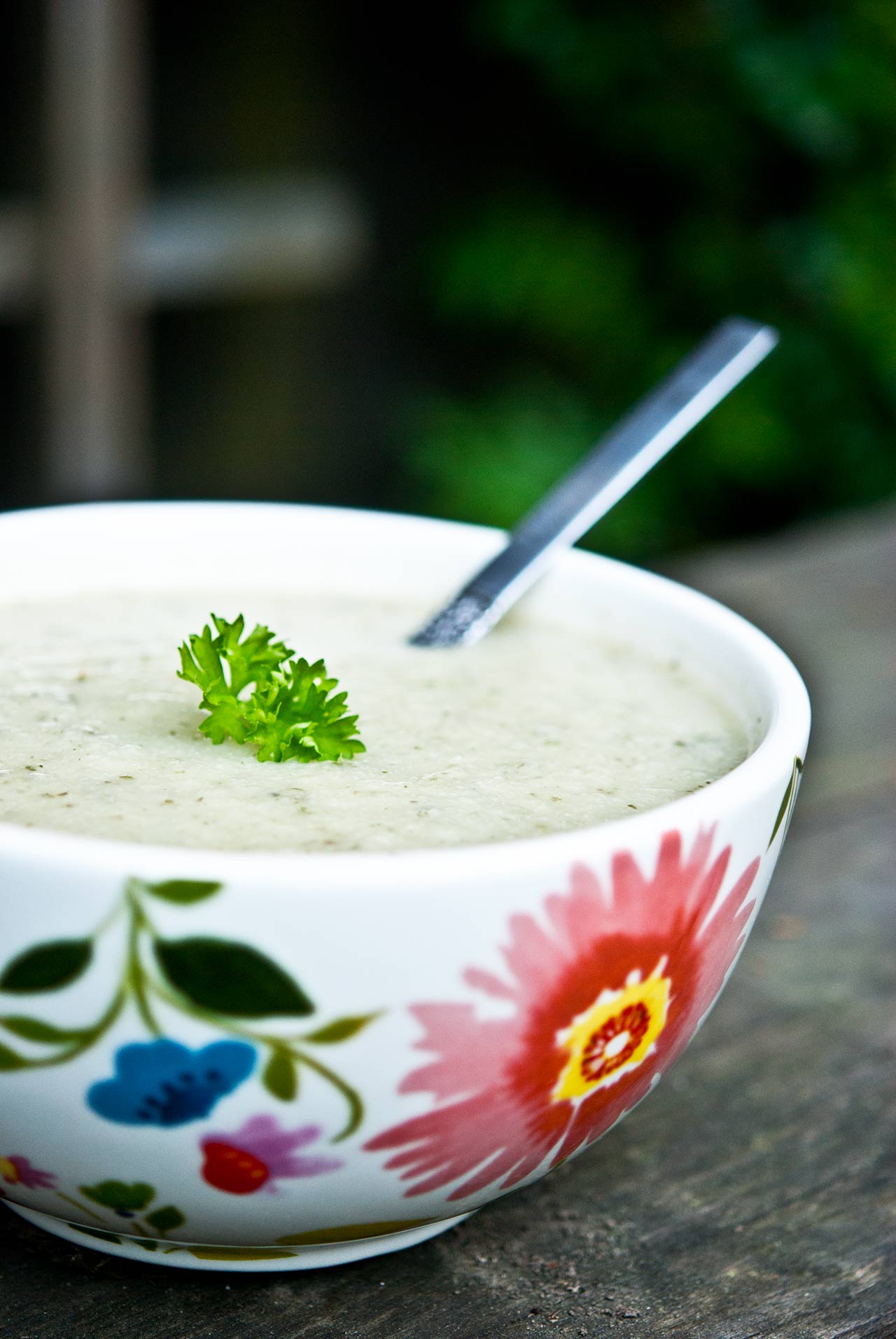 Side view of a bowl of Cauliflower Soup.