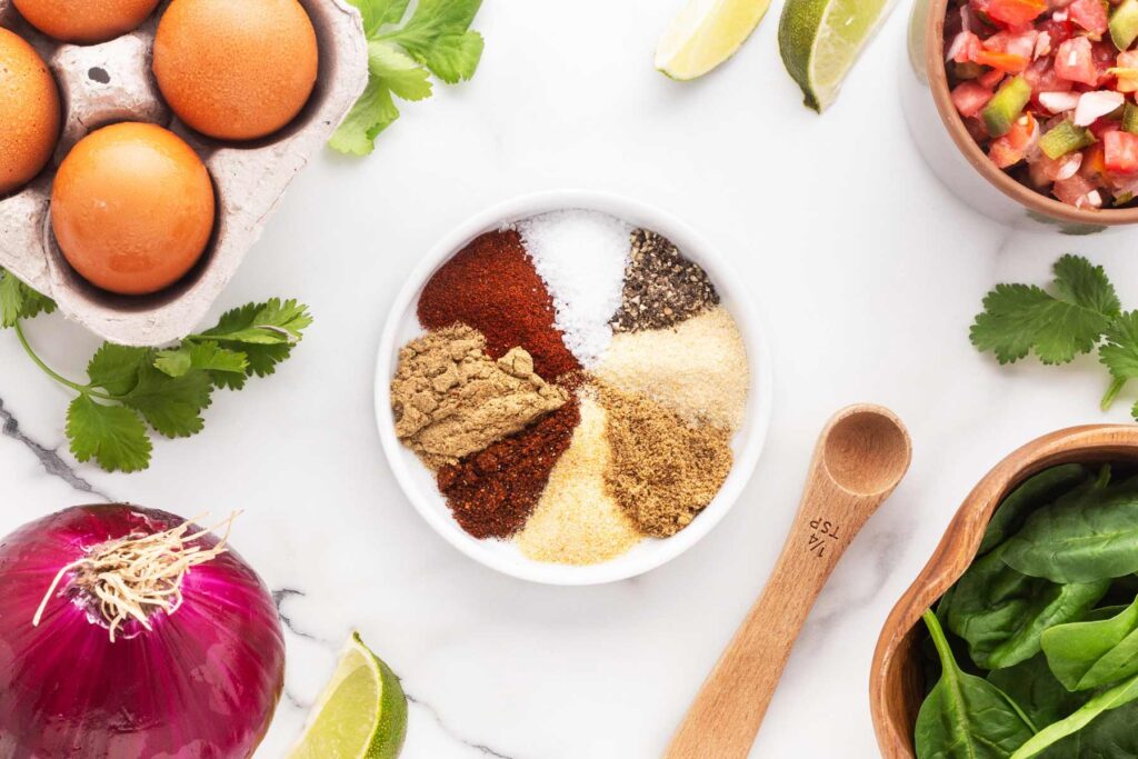 Spices for healthy breakfast tacos in a small white bowl.