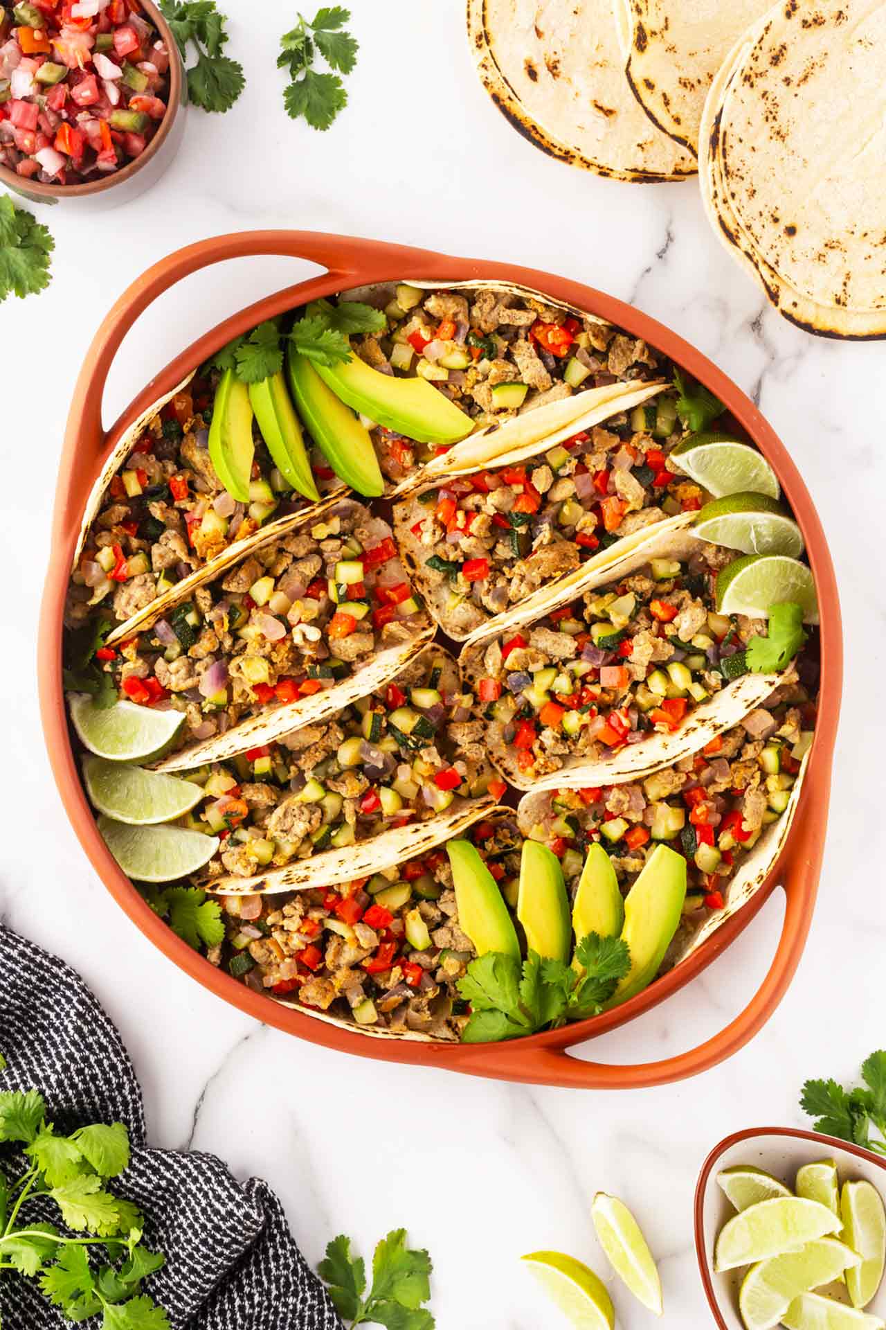Overhead view of several tacos prepared in a casserole dish.