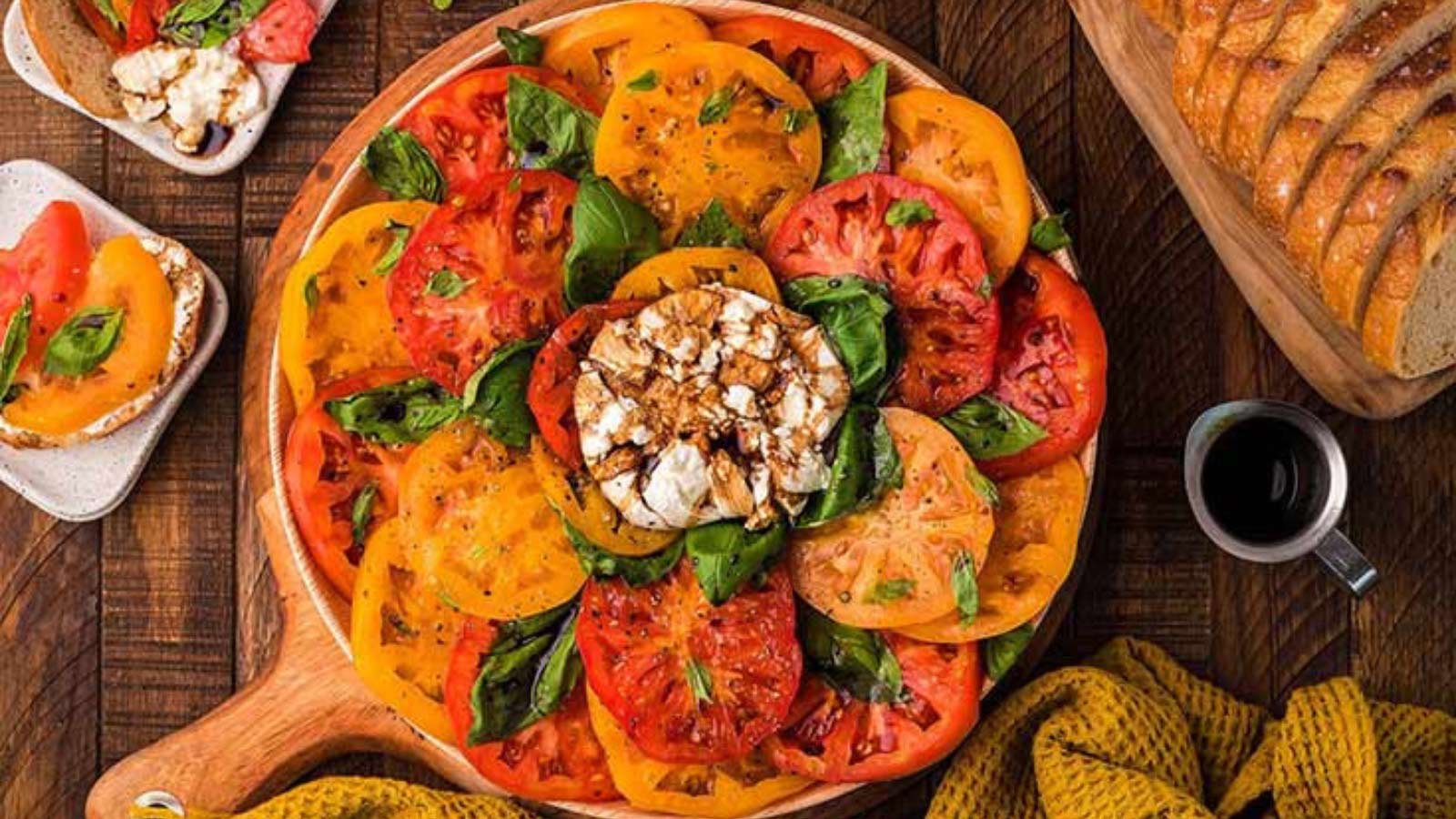 An overhead view of a platter filled with heirloom Italian burrata caprese salad.