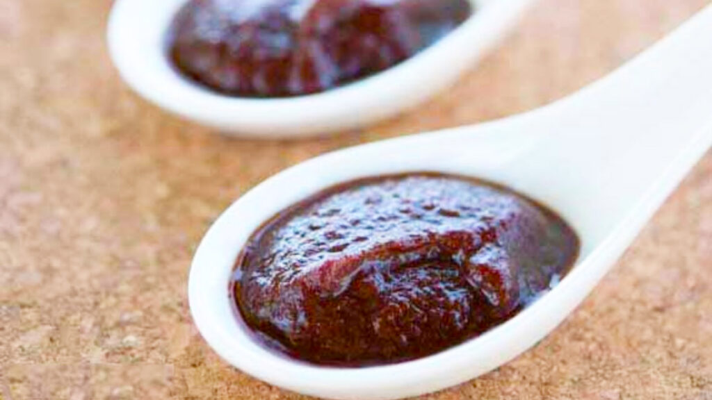 Homemade BBQ Sauce on two small serving spoons.