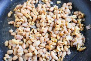 Closeup of butter beans in a skillet.