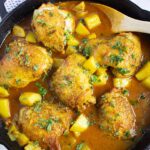 Overhead view of a skillet full of Moroccan chicken.