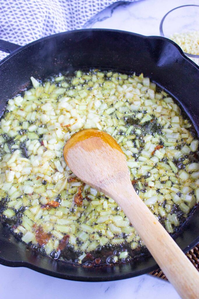 Onions sautéing in a skillet.