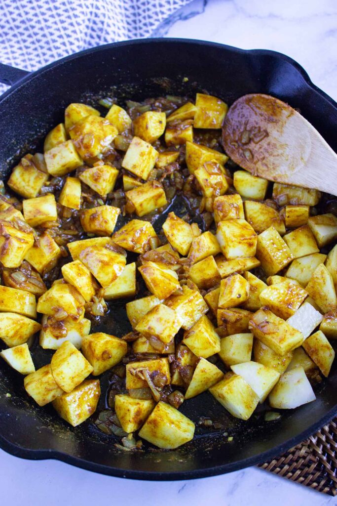 Sautéd potatoes in a skillet.