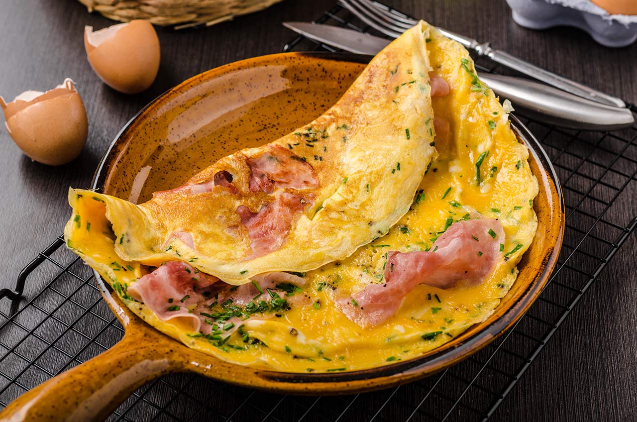 Ham and egg omelette, delicious and simple with fresh bread and herbs chive.