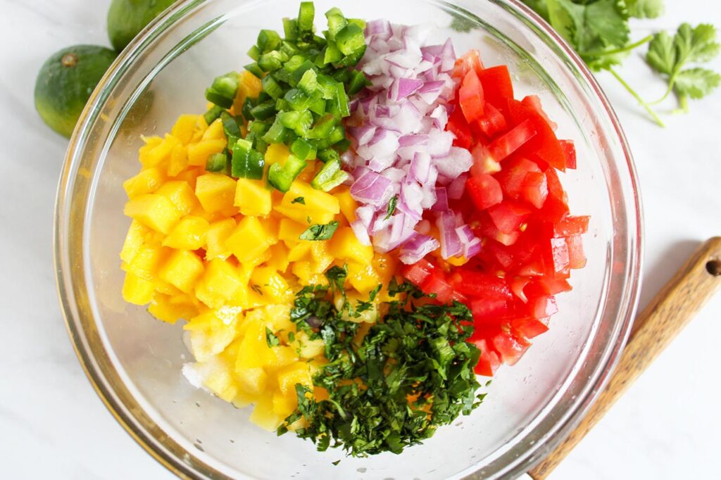 Pineapple Mango Salsa ingredients in a mixing bowl.