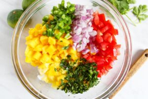 Pineapple Mango Salsa ingredients in a mixing bowl.