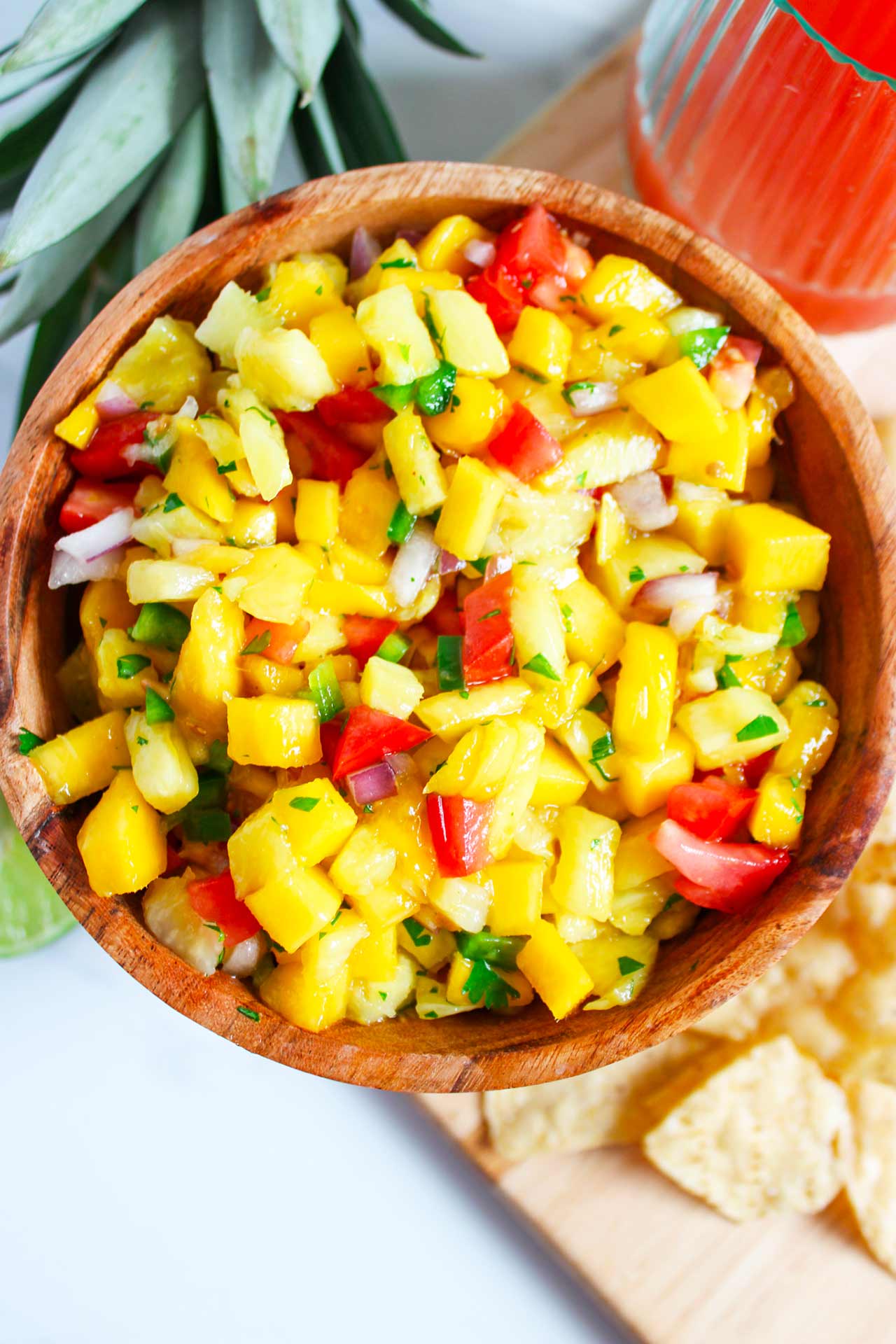 Full overhead view of a wood bowl filled with Pineapple Mango Salsa.