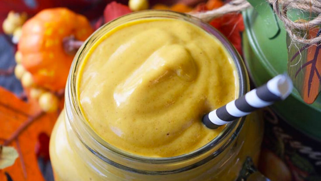 Overhead view of a glass mug full of pumpkin pie smoothie.