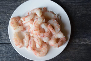 A pile of shrimp on a white plate.