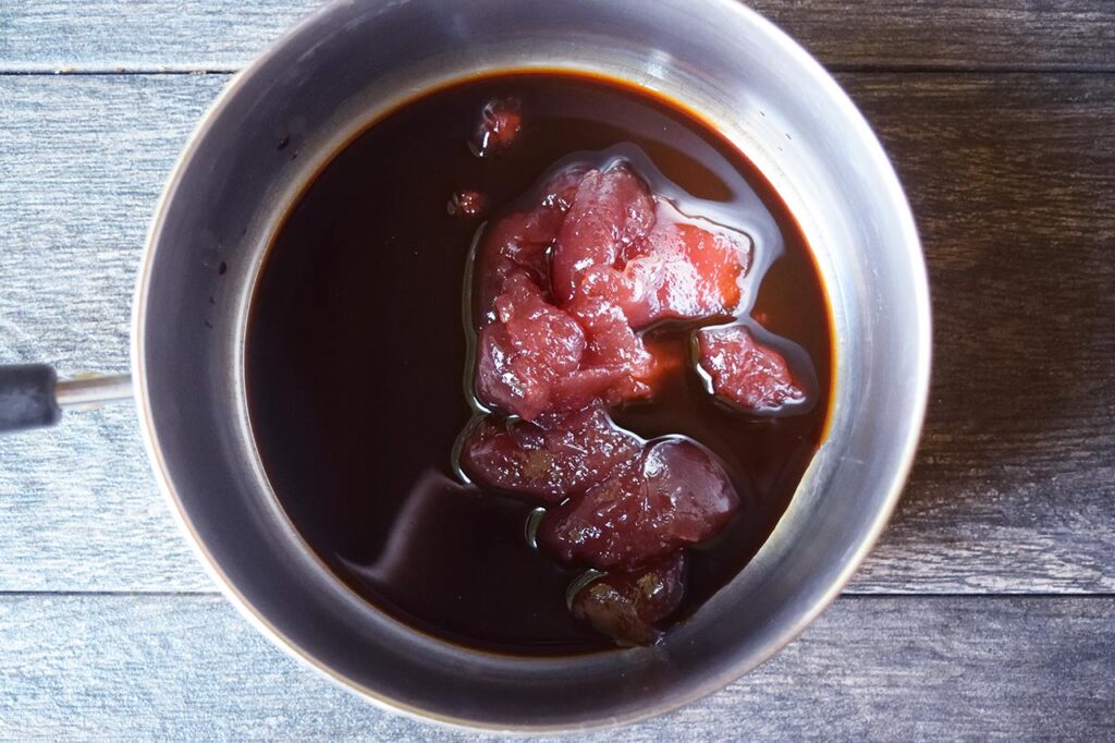 A pot with glaze ingredients in it for Sweet And Sour Meatballs..