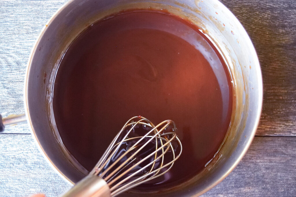 The finished glaze for Sweet And Sour Meatballs still in the pot it was heated in.