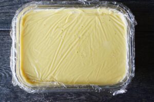 Plastic wrap covering the custard and laying directly on it.
