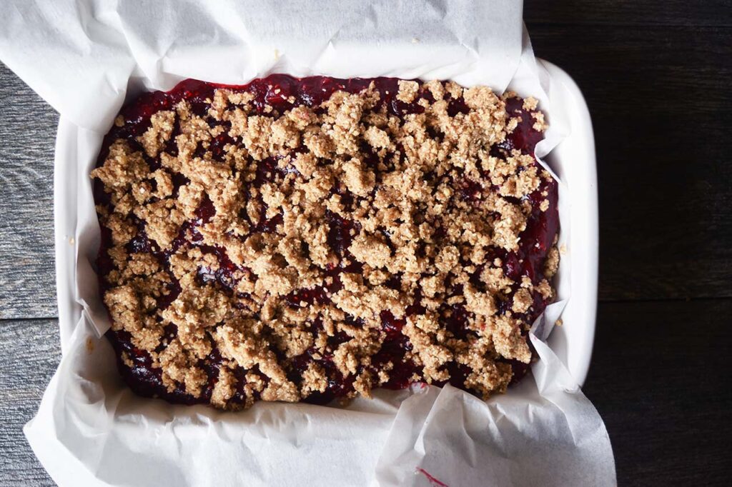 Cranberry mix and crumble topping added to crust in a baking dish.