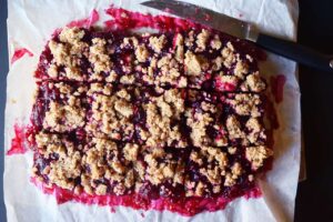 Cut cranberry bars on parchment.